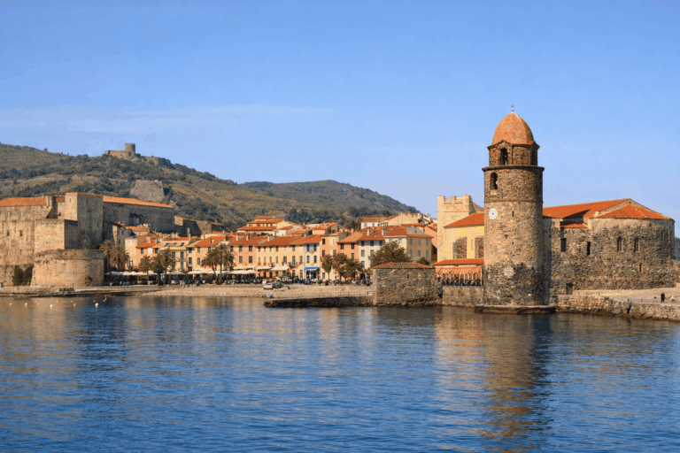 Vue de Collioure au printemps avec mer calme et clocher.